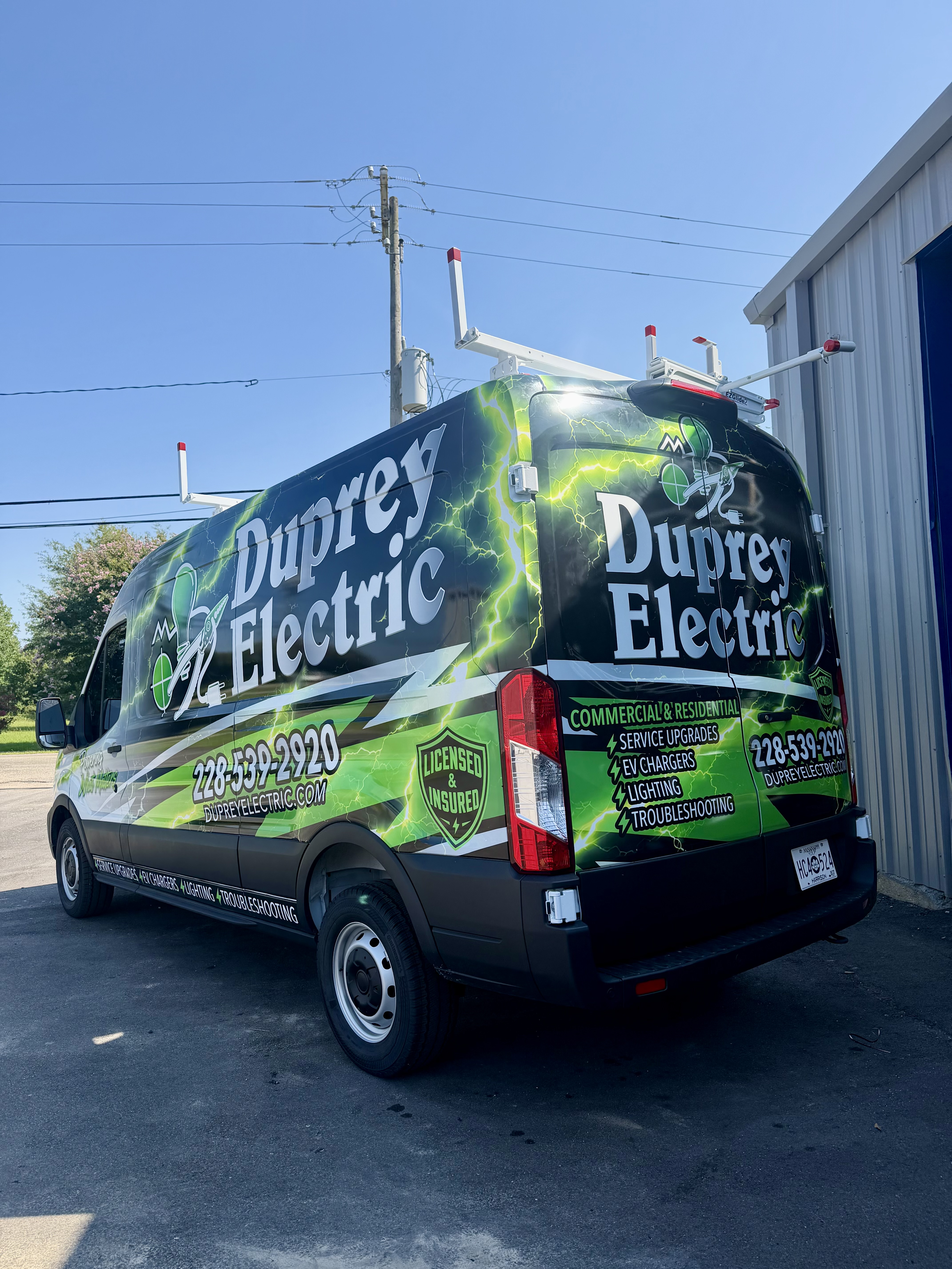 Duprey Electric work van with its green lightning wrap and original company logo
